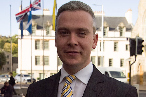 David at Parliament with flags